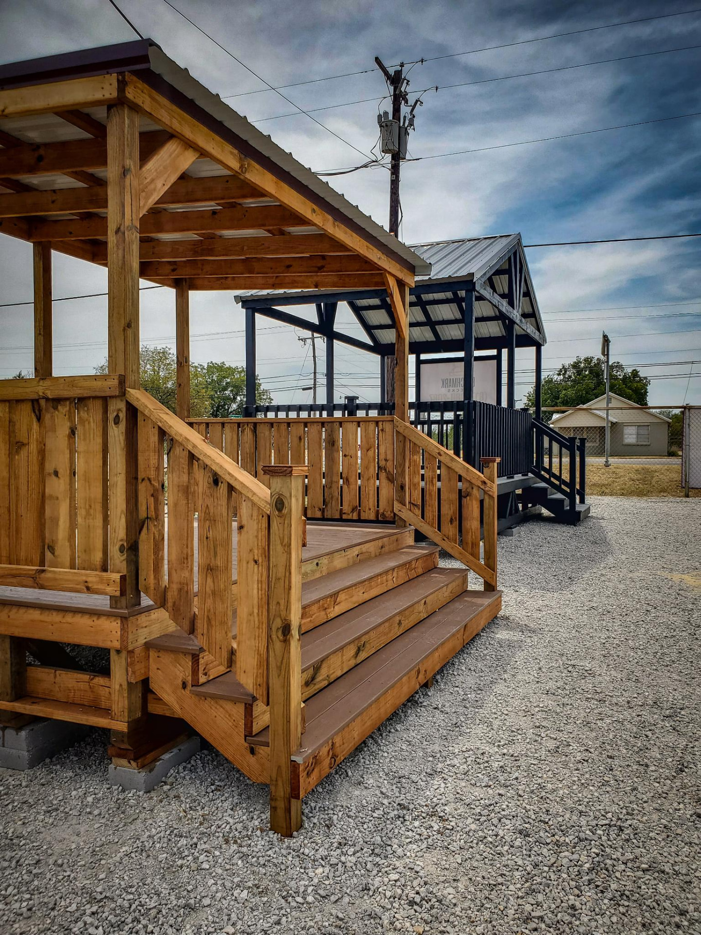 Cedar covered deck with steps and matching black covered deck on the lot