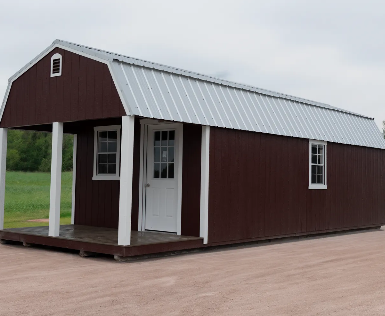 Brown lofted barn cabin shed with white posts and silver metal roof