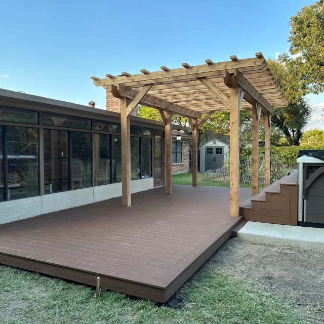Sunlit composite deck with cedar pergola and spa steps