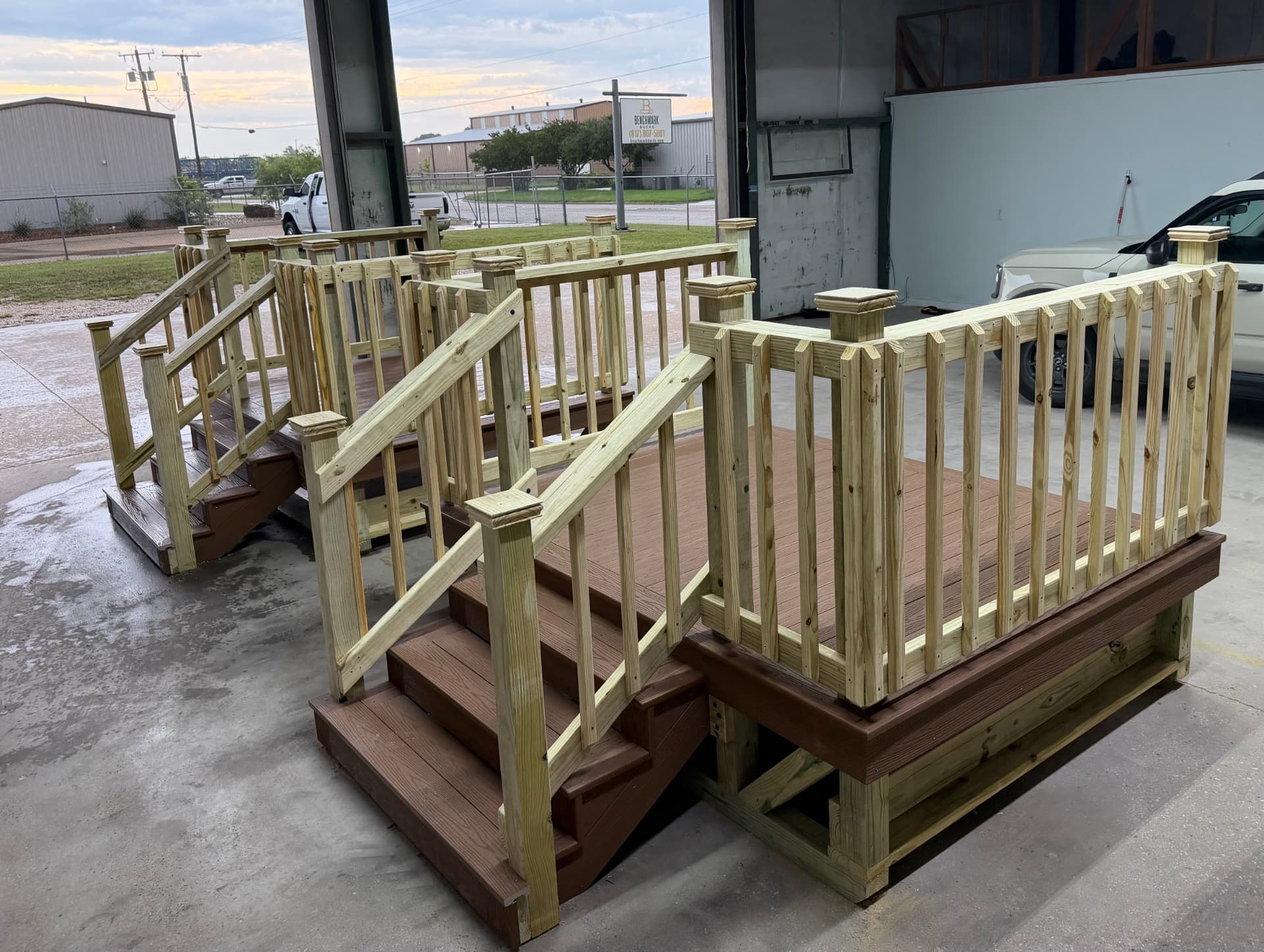 Two composite decks with treated railings and steps ready for delivery