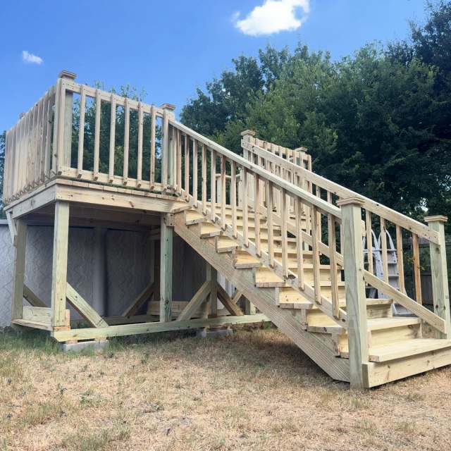 Above-ground pool deck with railing and stairs in pressure-treated pine